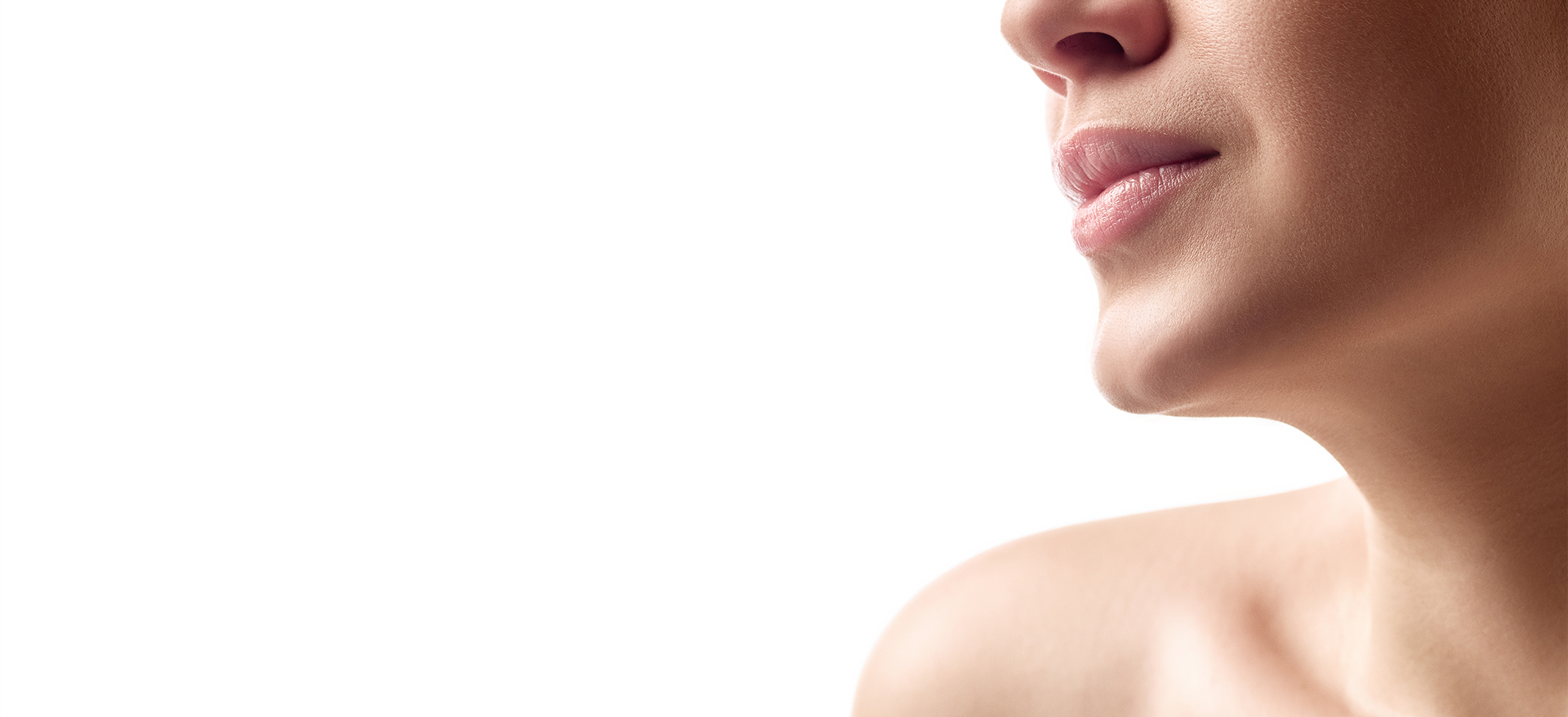 Close-up of a client's jawline, lips and neck.